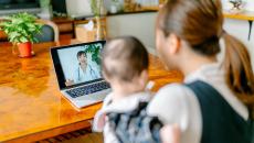 Mother consults doctors via telehealth with her baby